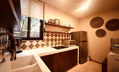 Departamento en venta 1 recamara en planta baja con jardín en Aldea Zama