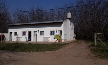 Amplio Lote con cuatro departamentos. En General Las Heras, total: U$S 120.000