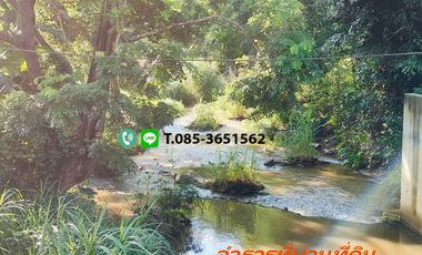 Land for sale in Chiang Mai Hangdong-Samoeng Road Near Flora Creek Hotel, a wide stream running through the land.