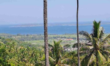 tanah dengan pemandangan laut dan sunset di pemenang dekat pelabuhan bangsal