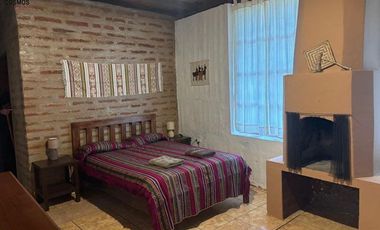 Venta de 17.800 m2 de terreno con 7 casas en Otavalo, apto para hostería