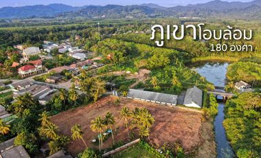 Almost 4 rai next to a canal is land for sale near Khao Lak Beach in Takua Pa, Phang Nga.